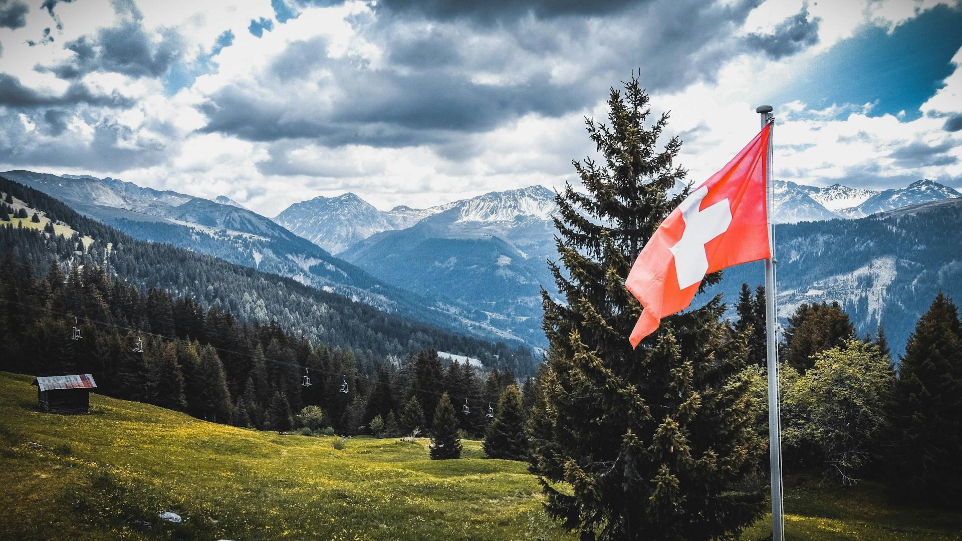 The Swiss online bank lowered its revenue and profit outlook after a weak first half for digital ass